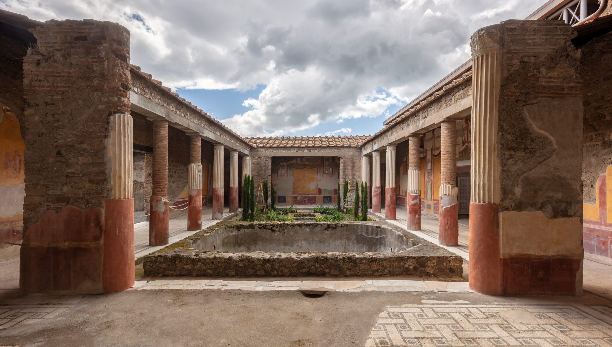 A colonnaded courtyard with painted walls in Pompeii